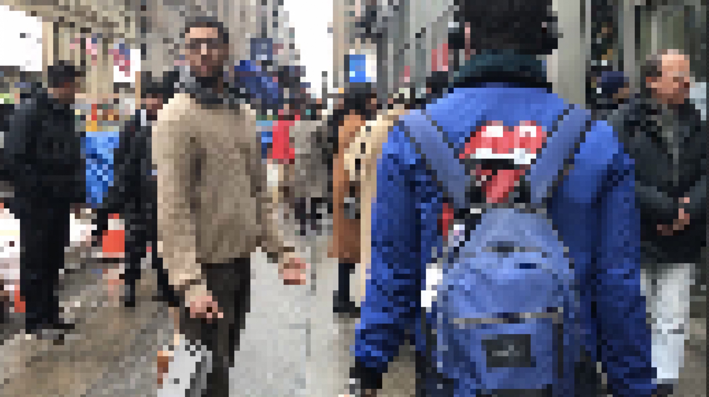 pixelated image of bodies of people walking past each other
